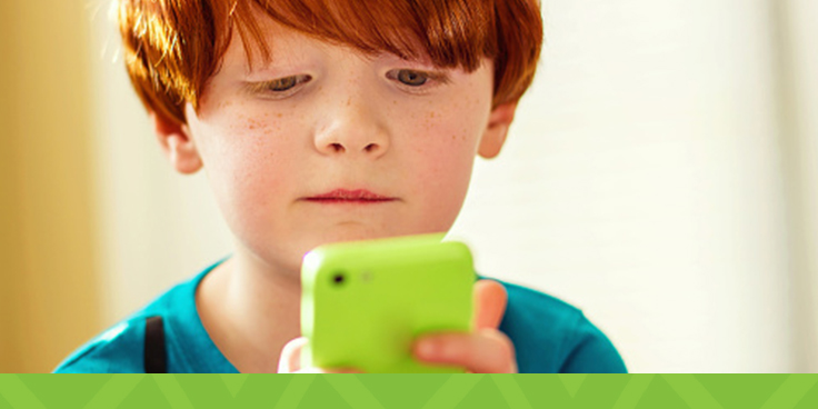 young boy playing on phone